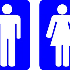 Białe sylwetki mężczyzny i kobiety na niebieskim tle. To standardowe oznaczenie wc, które informuje o dostępności toalet.