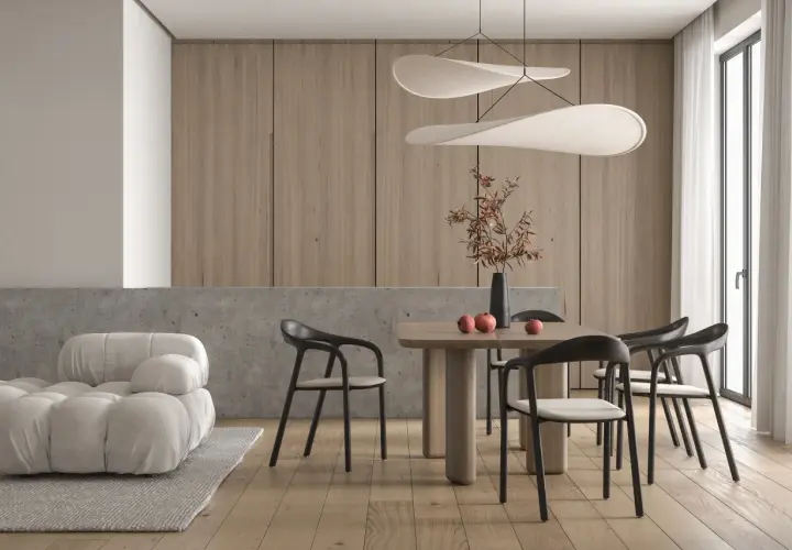 Minimalizm w domu: przytulna sofa, drewniany stół z krzesłami i dekoracje tworzą harmonię.