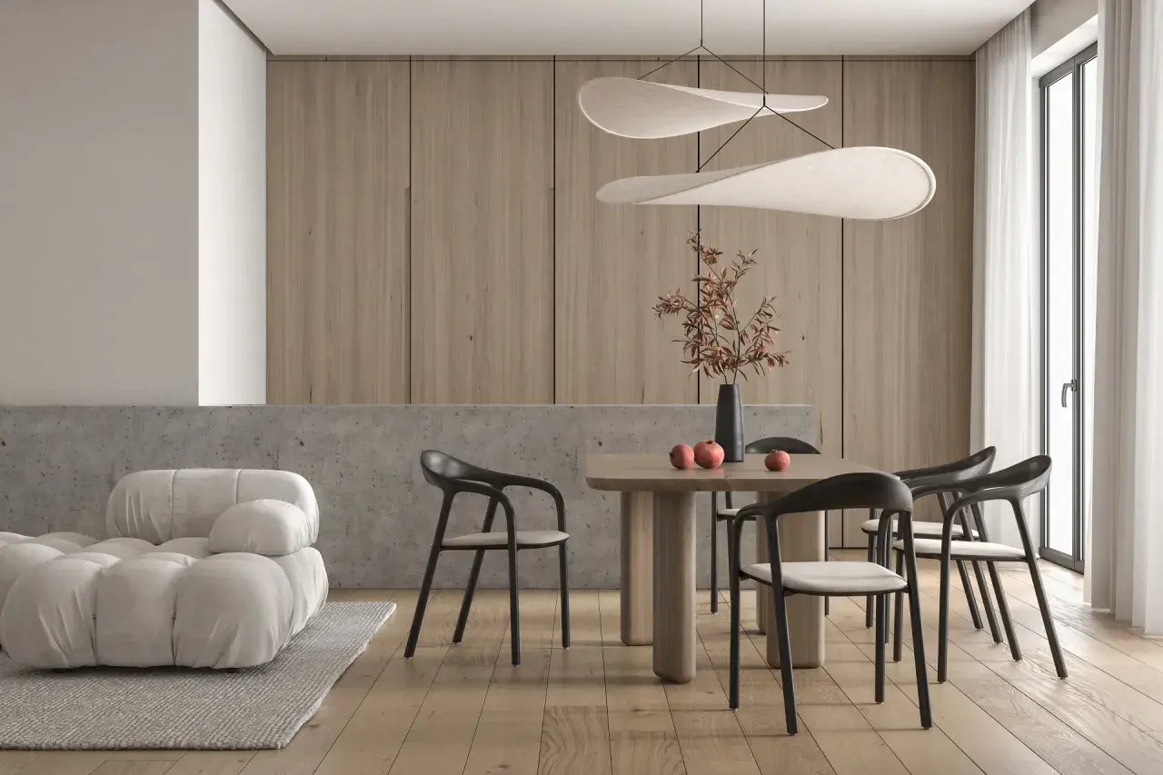 Minimalizm w domu: przytulna sofa, drewniany stół z krzesłami i dekoracje tworzą harmonię.
